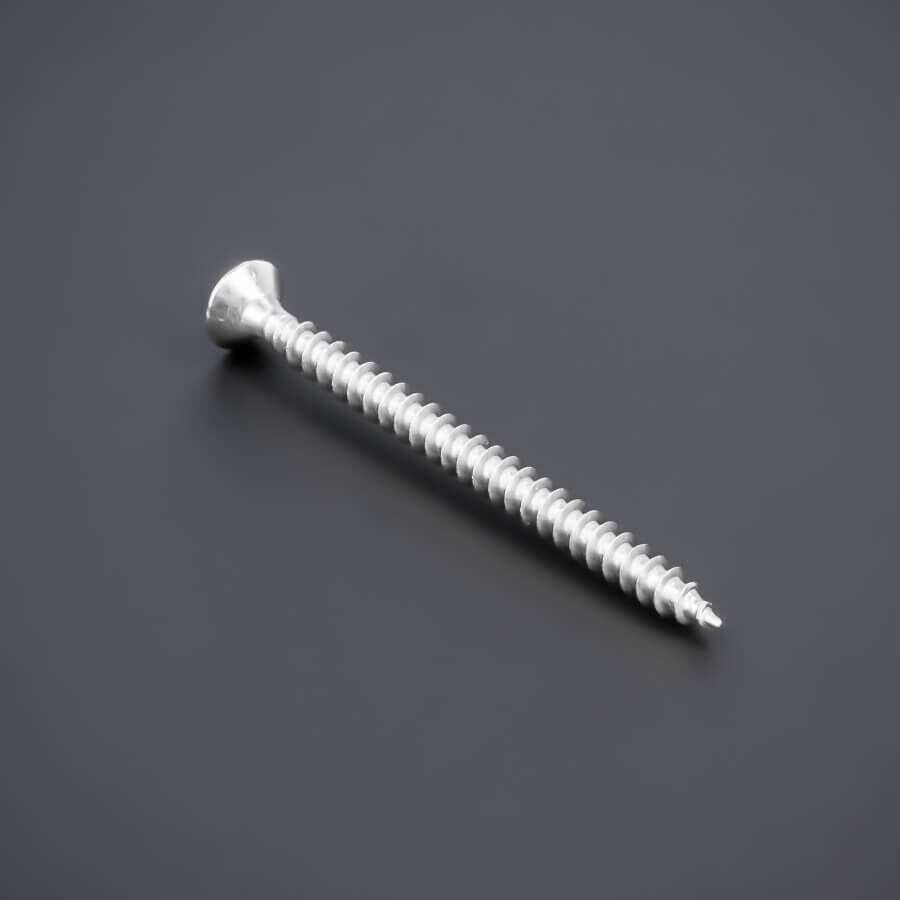 Schraube 3,5 x 50 mm, Edelstahl V2A - A2, Senkkopf - Kreuz Vollgewinde gedreht liegend auf dunklem Untergrund