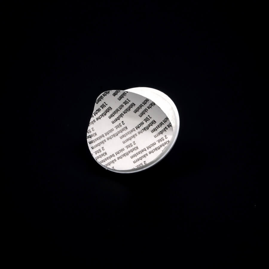 Bild-Haken-Aufhänger Ø 40 mm selbstklebend Rückseite Klebefläche auf dunklem Untergrund