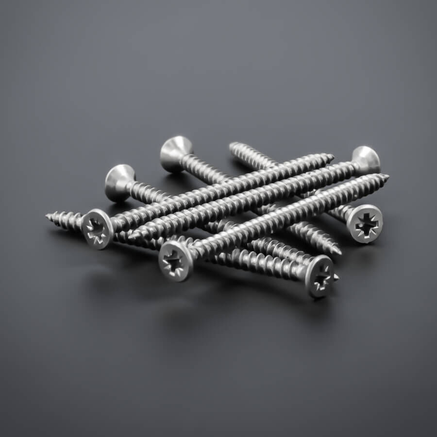 Senkkopfschraube 3x50 mm Edelstahl V2A - verstärkter Kopf | Kreuz größere Stückzahl liegend auf dunklem Untergrund