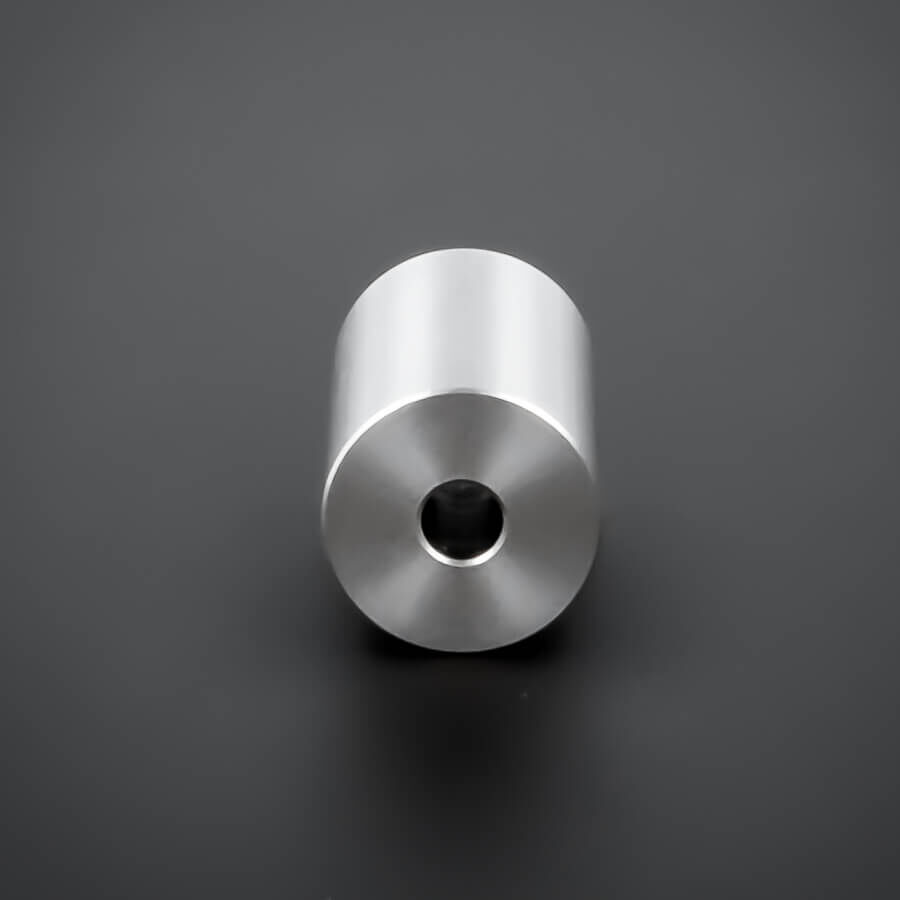 Distanzring Abstandshülse M5 V2A Ø18x30mm liegen frontal auf dunklem Untergrund