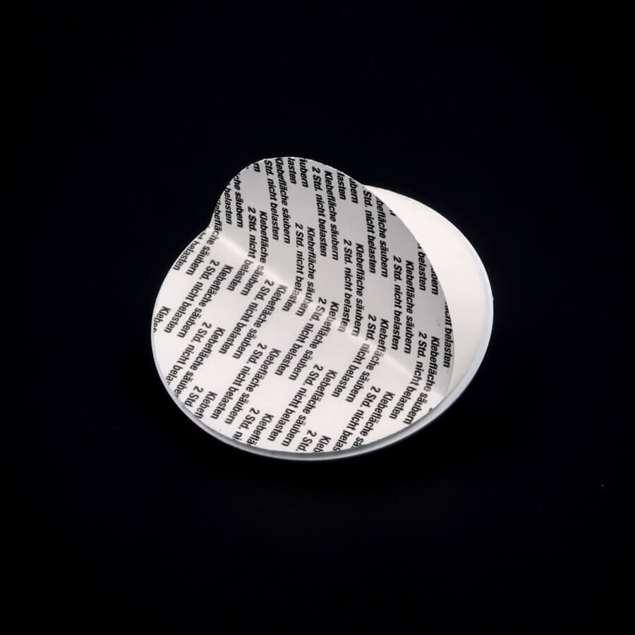 Bildaufhänger Ø60mm selbstklebend Rückseite Klebefläche auf dunklem Untergrund